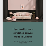 Lifestyle image of the vertical 16x24” inch easy to hang canvas wall art hung in a Halloween decorated, pink living room hung above a couch with pumpkins on it with graphic saying "High quality, non-stretched canvas made in Canada."