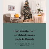 Lifestyle image of the vertical, 24x32 inch easy to hang canvas wall art hung in a christmas decorated living room hung above a couch beside a christmas tree with graphic saying "High quality, non-stretched canvas made in Canada"