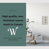 Lifestyle image of the vertical, 12x18" inch easy to hang canvas wall art hung over a bench in a bathroom with graphic saying "High quality, non-stretched canvas made in Canada"