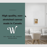 Lifestyle image of the vertical, 12x18 inch easy to hang canvas wall art hung in a dining room of a restaurant above a booth table with graphic saying "High quality, non-stretched canvas made in Canada"