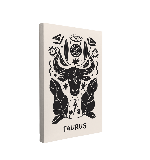 Single, 2:3 vertical easy to hang canvas print on a transparent background featuring an image of a black and white interpretation of the Taurus zodiac symbol featuring a cow bull's head surrounded by floral, eyes and leaves in a nordic art style.