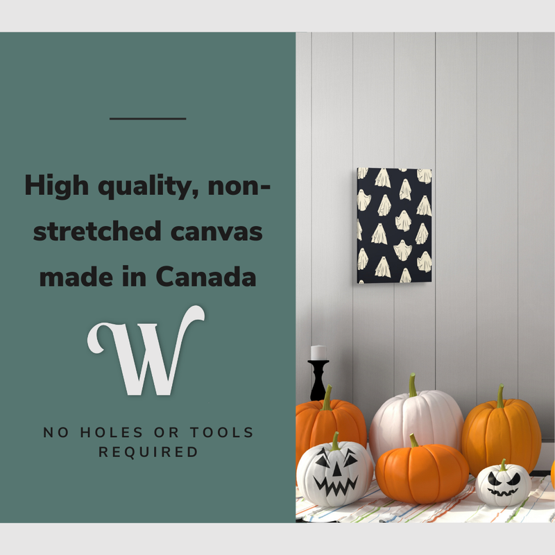 Lifestyle image of the vertical 12x18” inch easy to hang canvas wall art hung in a Halloween decorated foyer above some pumpkins with graphic saying "High quality, non-stretched canvas made in Canada."