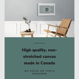 Lifestyle image of the horizontal, 20x30” inch easy to hang canvas wall art hung in a living room above a table and chair with graphic saying "High quality, non-stretched canvas made in Canada"