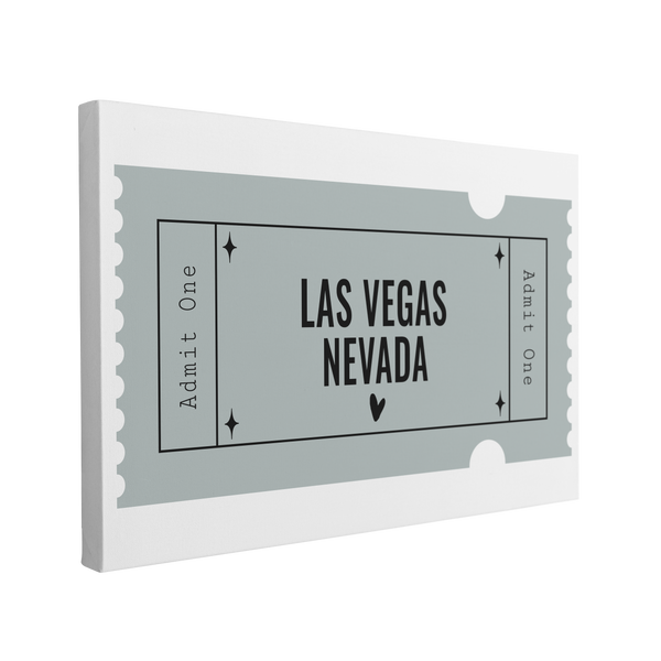 Single, 2:3 horizontal easy to hang canvas print on a transparent background featuring an image of a blue graphic of a Admit One ticket with black font "Las Vegas, Nevada"