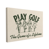 Single, 2:3 horizontal easy to hang canvas print on a transparent background featuring an image of a dark forest green vintage newspaper ad for golf with four men and woman walking with golf clubs on a green with "Play Golf" font large behind them and underneath says, "The Game of a Lifetime" on a white-yellow background.